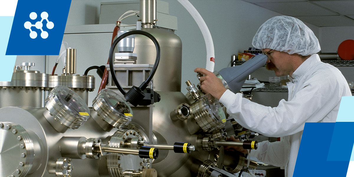 a man in a lab coat is working on a machine